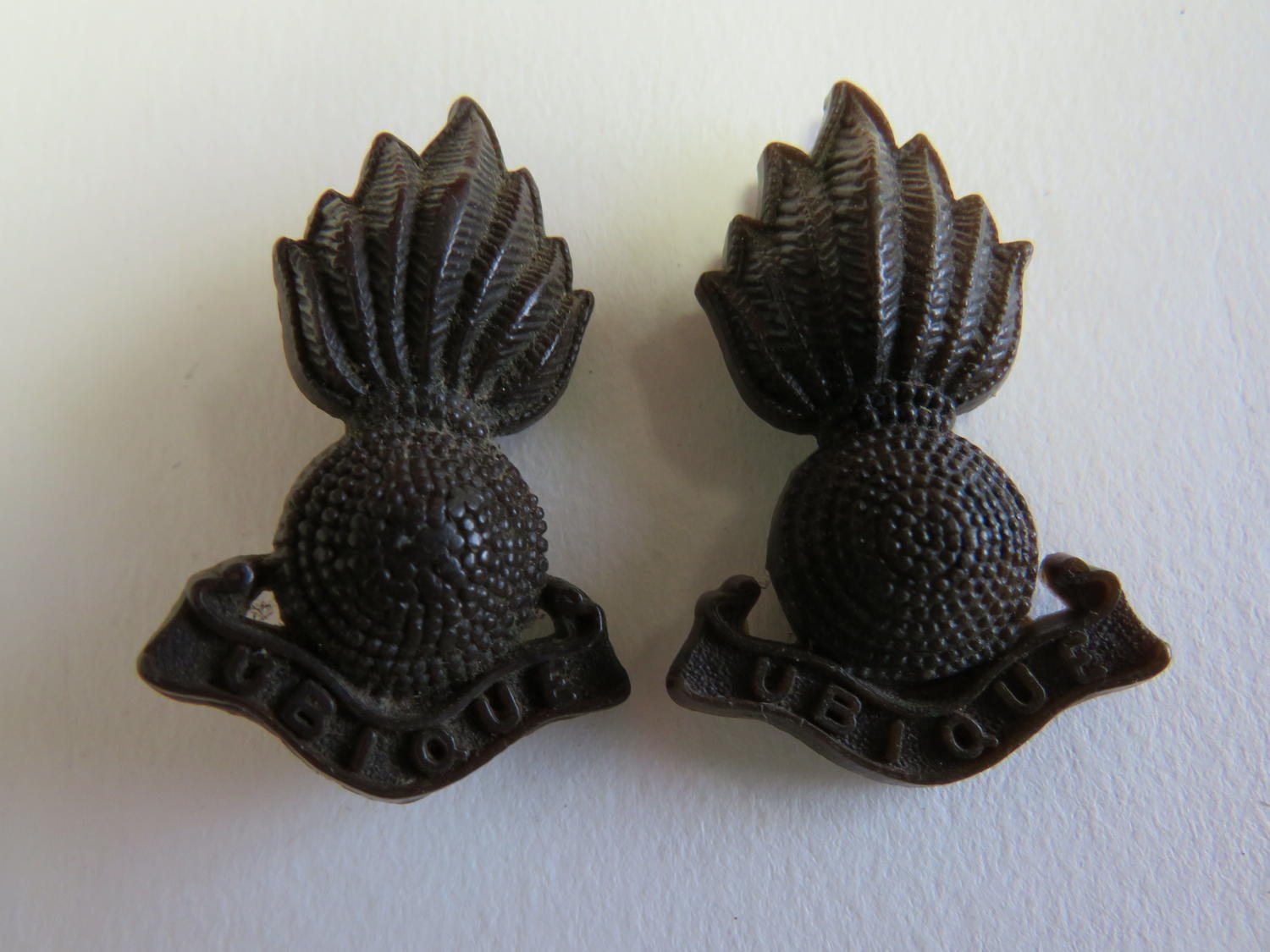 Two Plastic Economy Royal Artillery Collar/Forage Badges